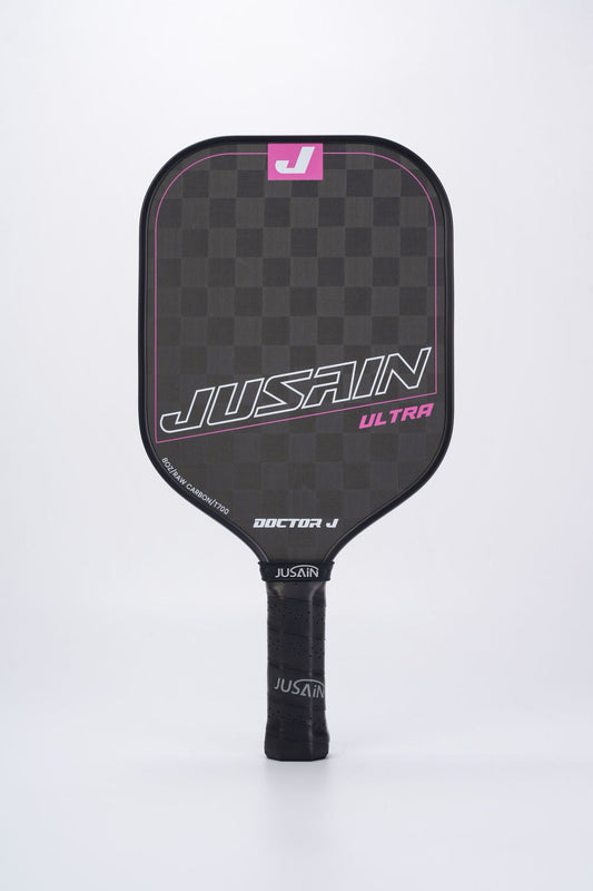 Full front view of the JUSSAIN ULTRA pickleball paddle featuring a black carbon fiber surface with pink accent lines and branding. This is a striking option when exploring where to buy pickleball paddles, with a unique design suitable for players seeking a distinctive look.