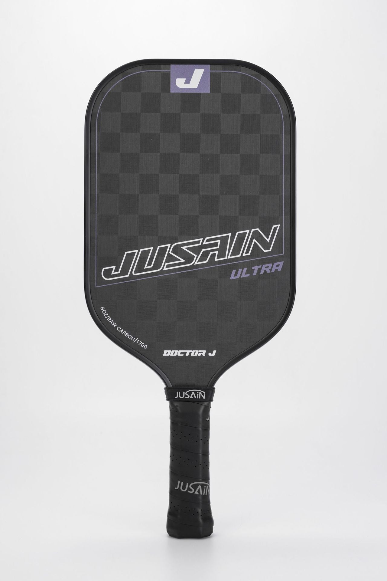 Close-up of the black and purple JUSAIN ULTRA pickleball paddle. The paddle face features 8OZ RAW CARBON/T700 carbon fiber. This paddle is a color option for questions about which pickleball paddle is best for me.