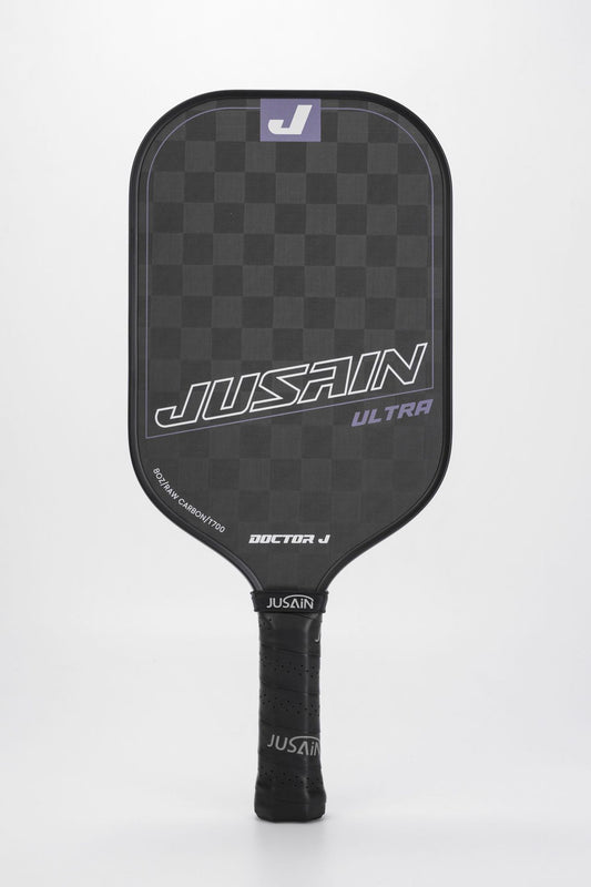 Close-up of the black and purple JUSAIN ULTRA pickleball paddle. The paddle face features 8OZ RAW CARBON/T700 carbon fiber. This paddle is a color option for questions about which pickleball paddle is best for me.