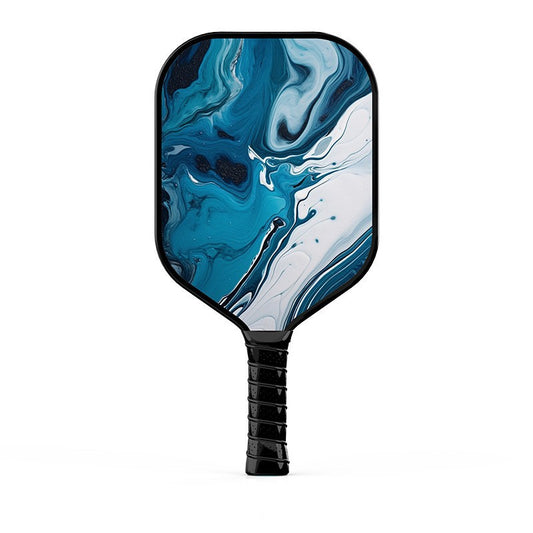 Xephira 16mm defensive paddle featuring an abstract blue, teal, and white fluid art (marble) pattern. This beautifully designed paddle answers the aesthetic criteria of what are good pickleball paddles.