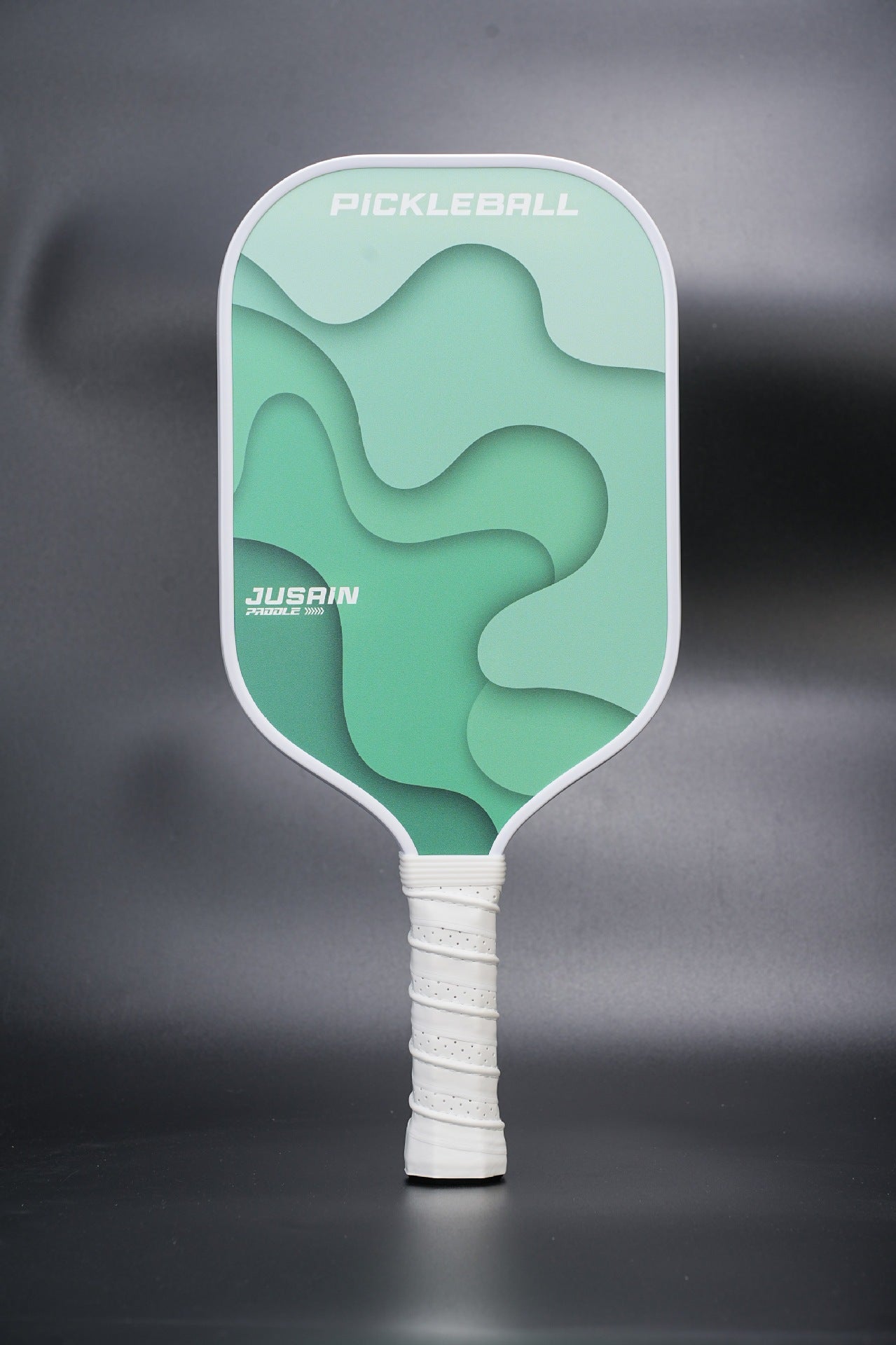 Xephira pickleball paddle with a green wave layered design. If you are asking what is the best pickleball paddle for beginners, this 16mm face offers a larger sweet spot and stability.