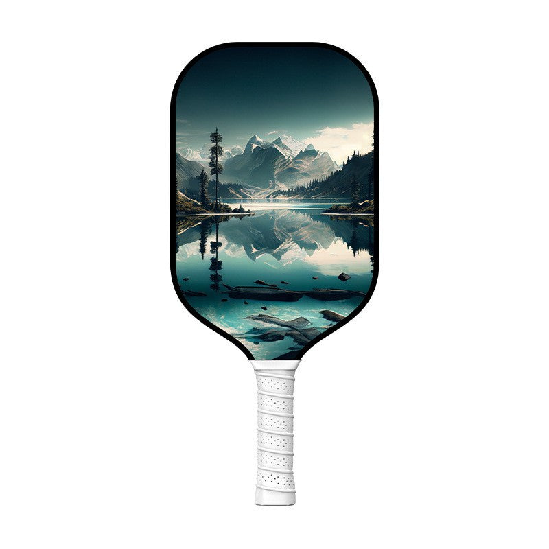 A pickleball paddle featuring a stunning Glacier/Lake/Mountain art design, with a white grip. The unique nature USP is for players looking for style while learning how to hold a pickleball paddle.