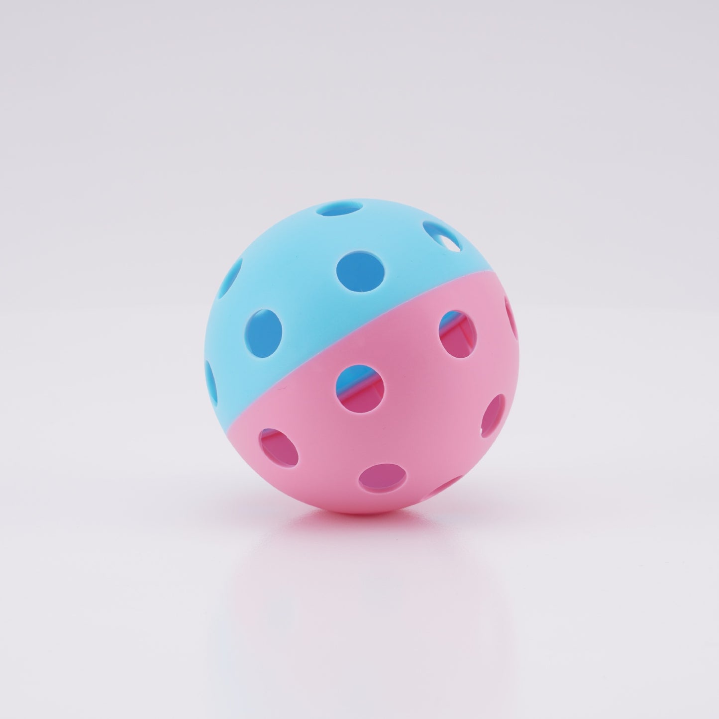 Dual-color Blue/Pink 26-hole TPE indoor pickleball. How to hold a pickleball paddle for dinks.