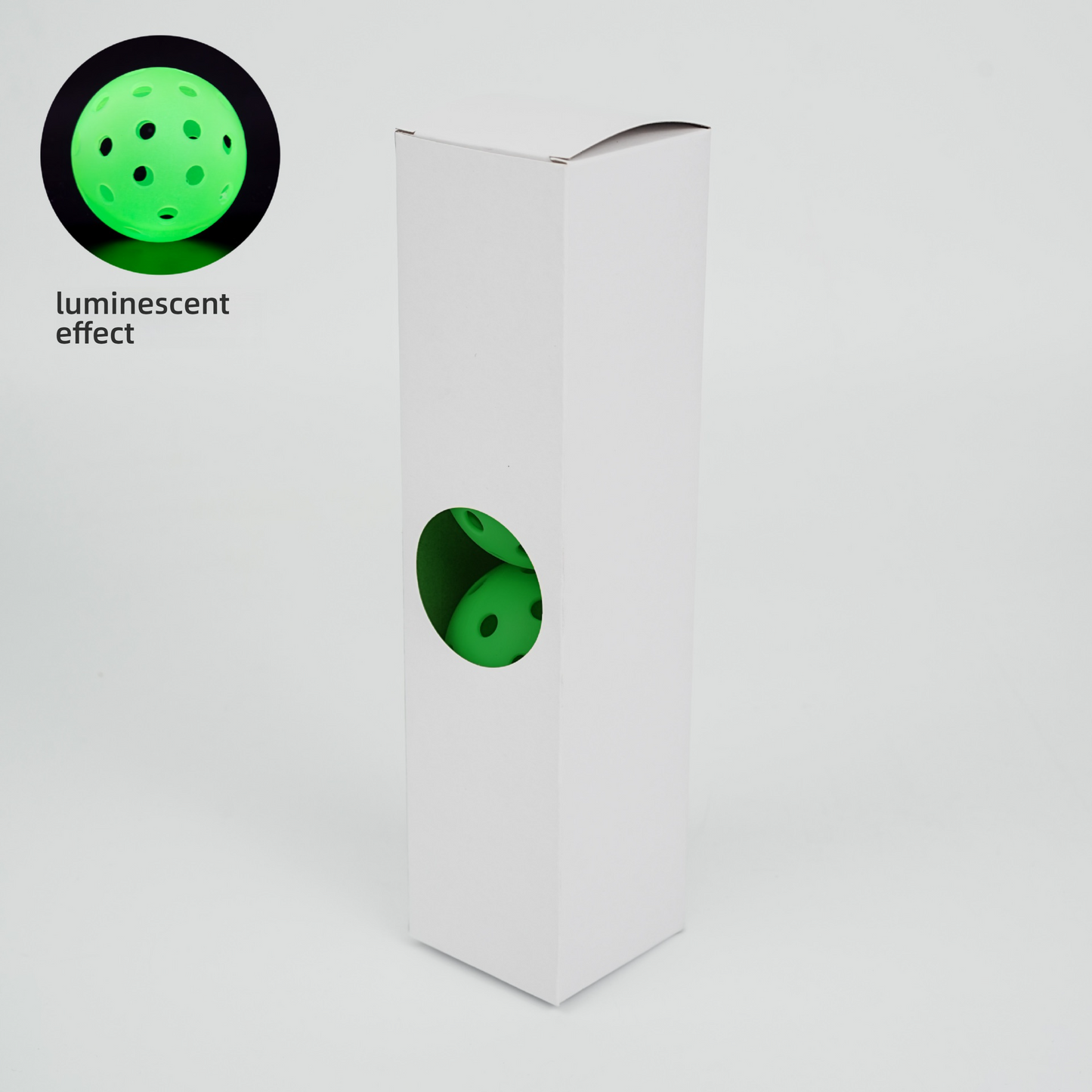 Glow-in-the-dark TPE 26-hole pickleballs in a white 4-ball box, showing luminescent effect.