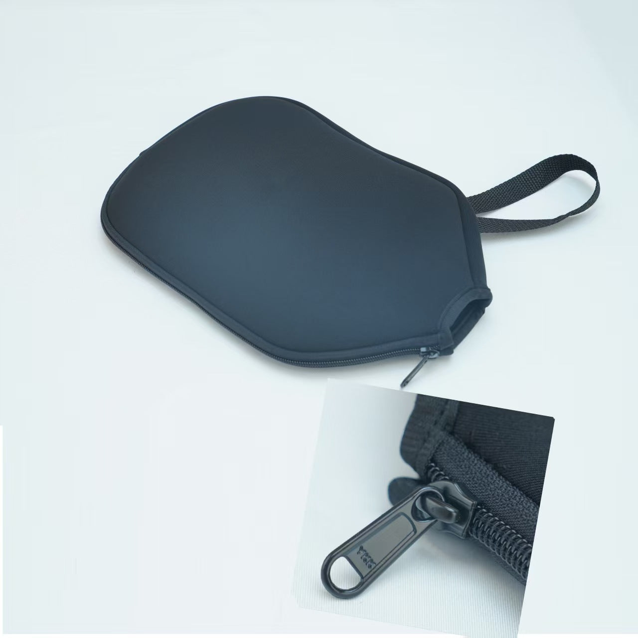 Black neoprene sleeve showing YKK zipper detail. What makes a pickleball paddle good is its protection.